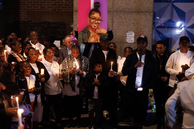 <p>The mother of Elianne Andam (centre left), who was stabbed to death in Croydon, arrives with other family members and friends for the vigil</p>