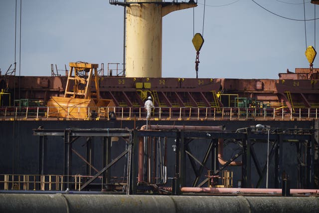 Workmen continue to search the MV Matthew cargo ship at Marino Point in Co Cork after it was seized by authorities. Tuesday, October 3. (Niall Carson/PA)