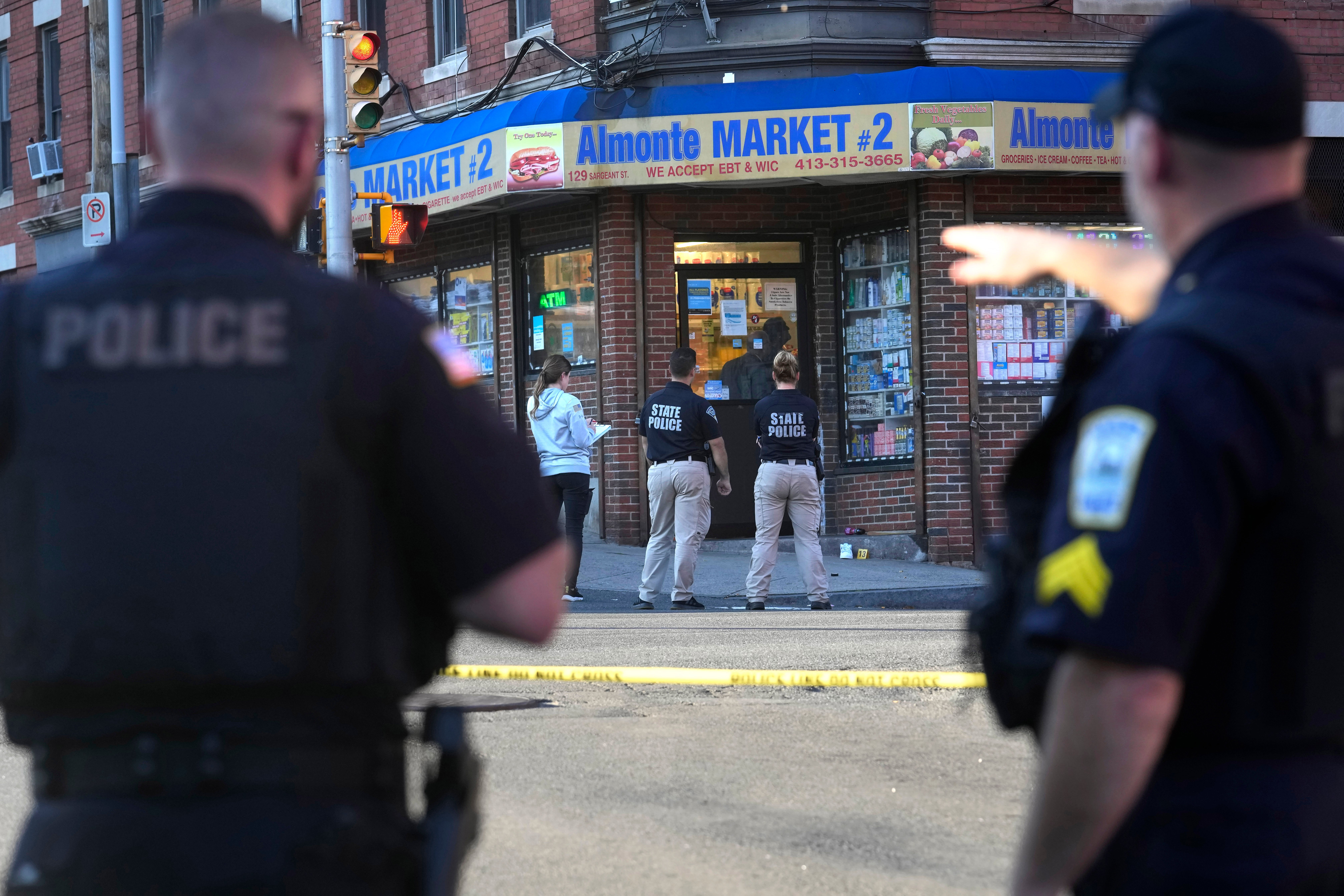 Law enforcement officials investigate the scene where multiple were shot, Wednesday, Oct. 4, 2023, in Holyoke, Mass.