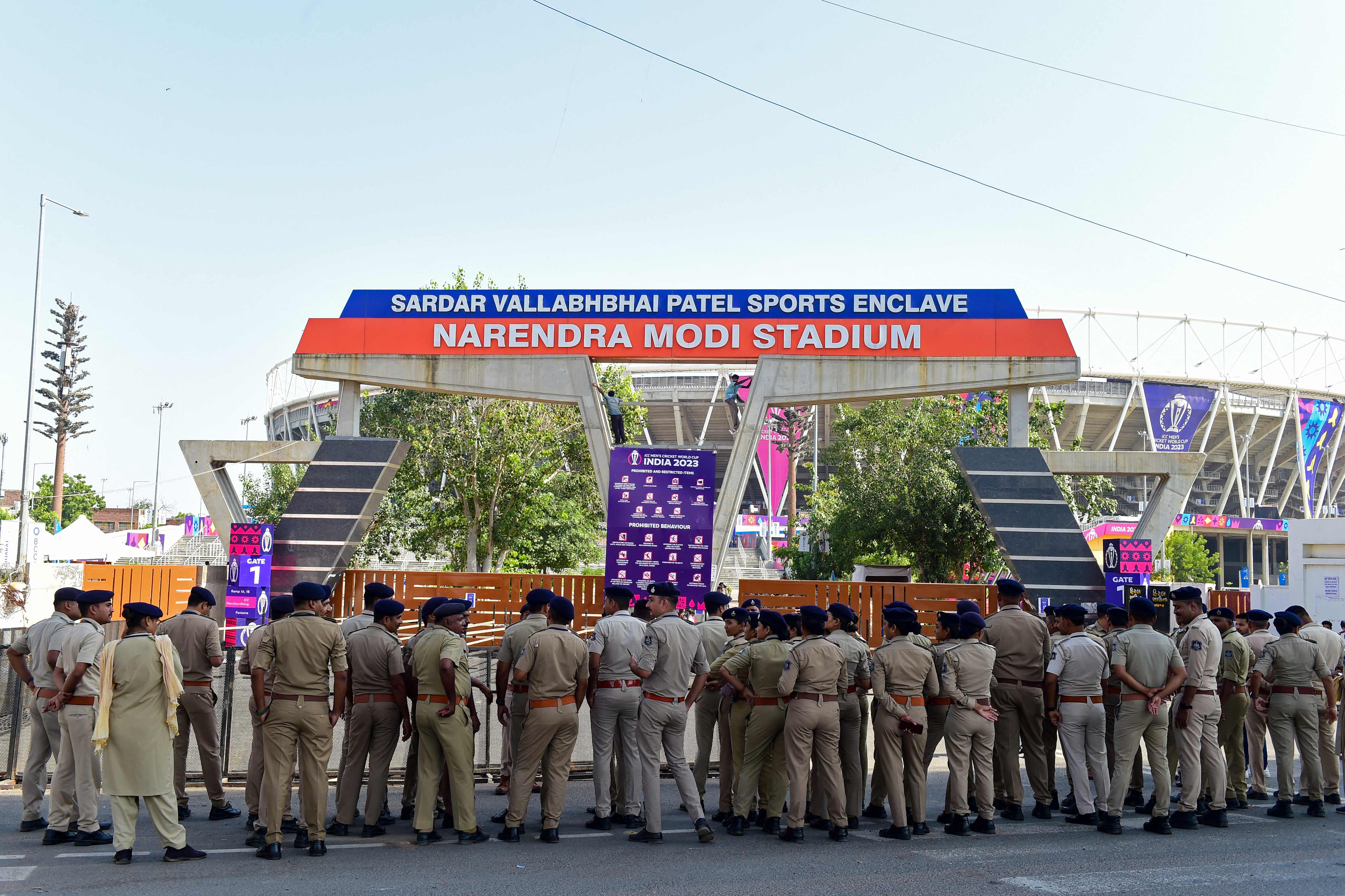 Police personnel gather outside the Narendra Modi Stadium in Ahmedabad on 4 October 2023 ahead of the ICC men's cricket World Cup opening match between England and New Zealand