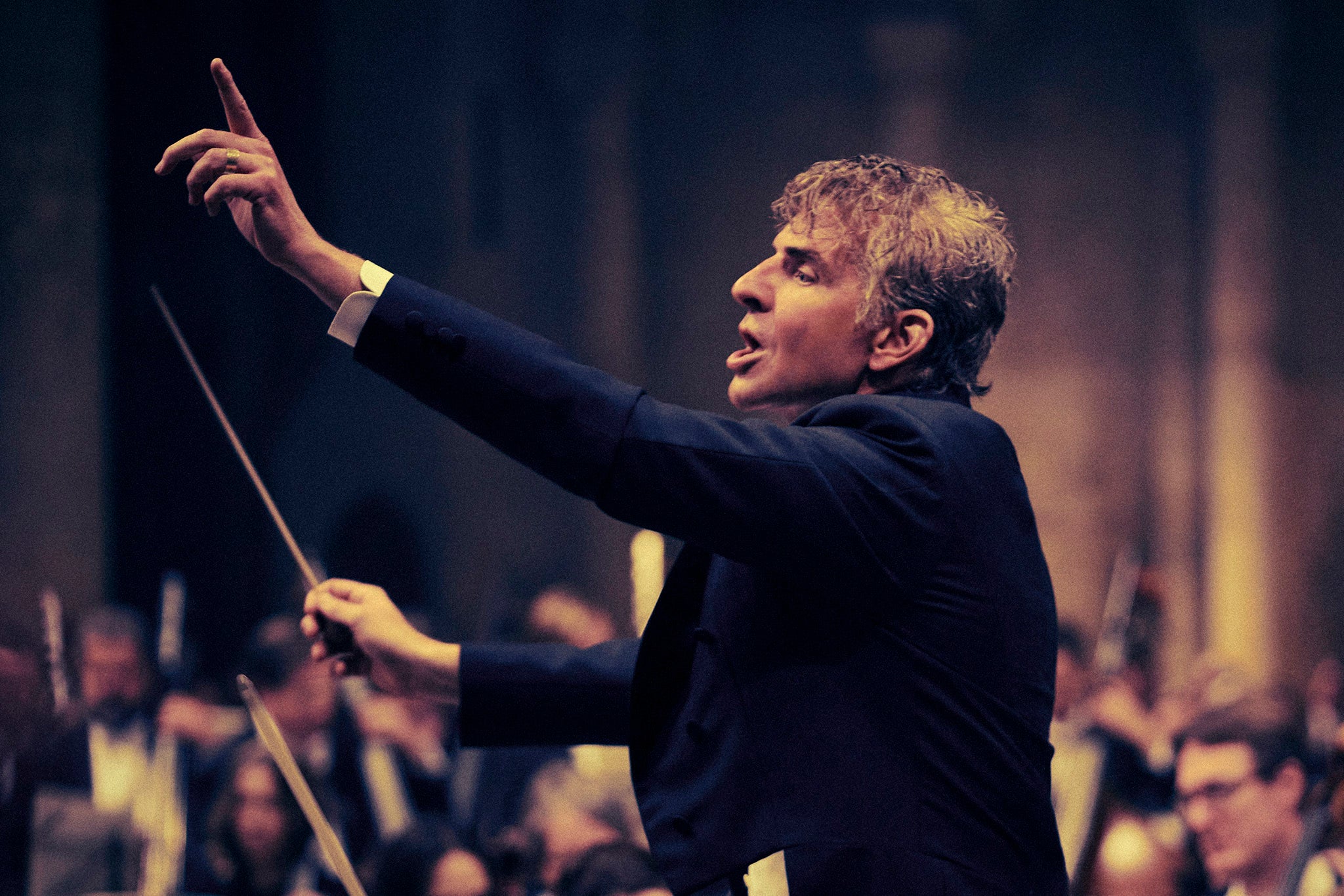 <p>Hollywood maestro: Bradley Cooper (plus his prosthetic nose) conducts an orchestra as Leonard Bernstein in his new film, ‘Maestro'</p>