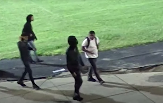 <p>Four people were seen walking across the campus in the footage </p>