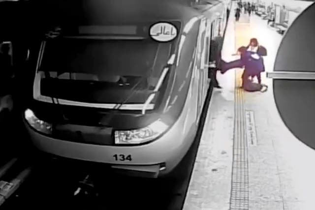 <p>In this image from surveillance video aired by Iranian state television, women pull 16-year-old Armita Geravand from a train carriage on the Tehran Metro in Tehran, Iran, on 1 October </p>