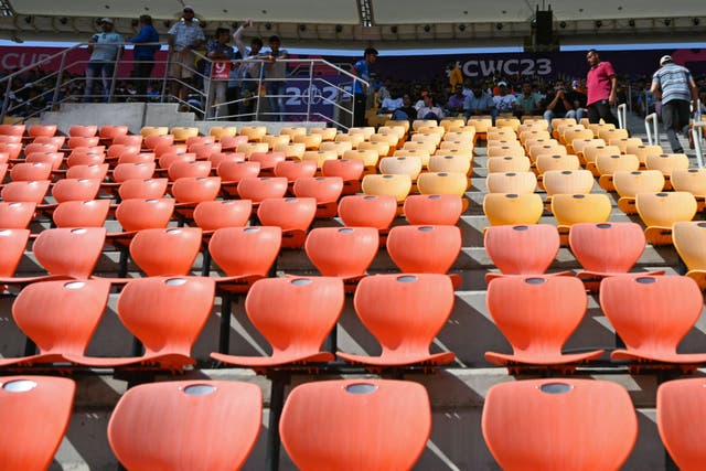<p>Spectators watch the 2023 ICC men's cricket World Cup one-day international (ODI) match between England and New Zealand at the Narendra Modi Stadium in Ahmedabad on 5 October 2023</p>