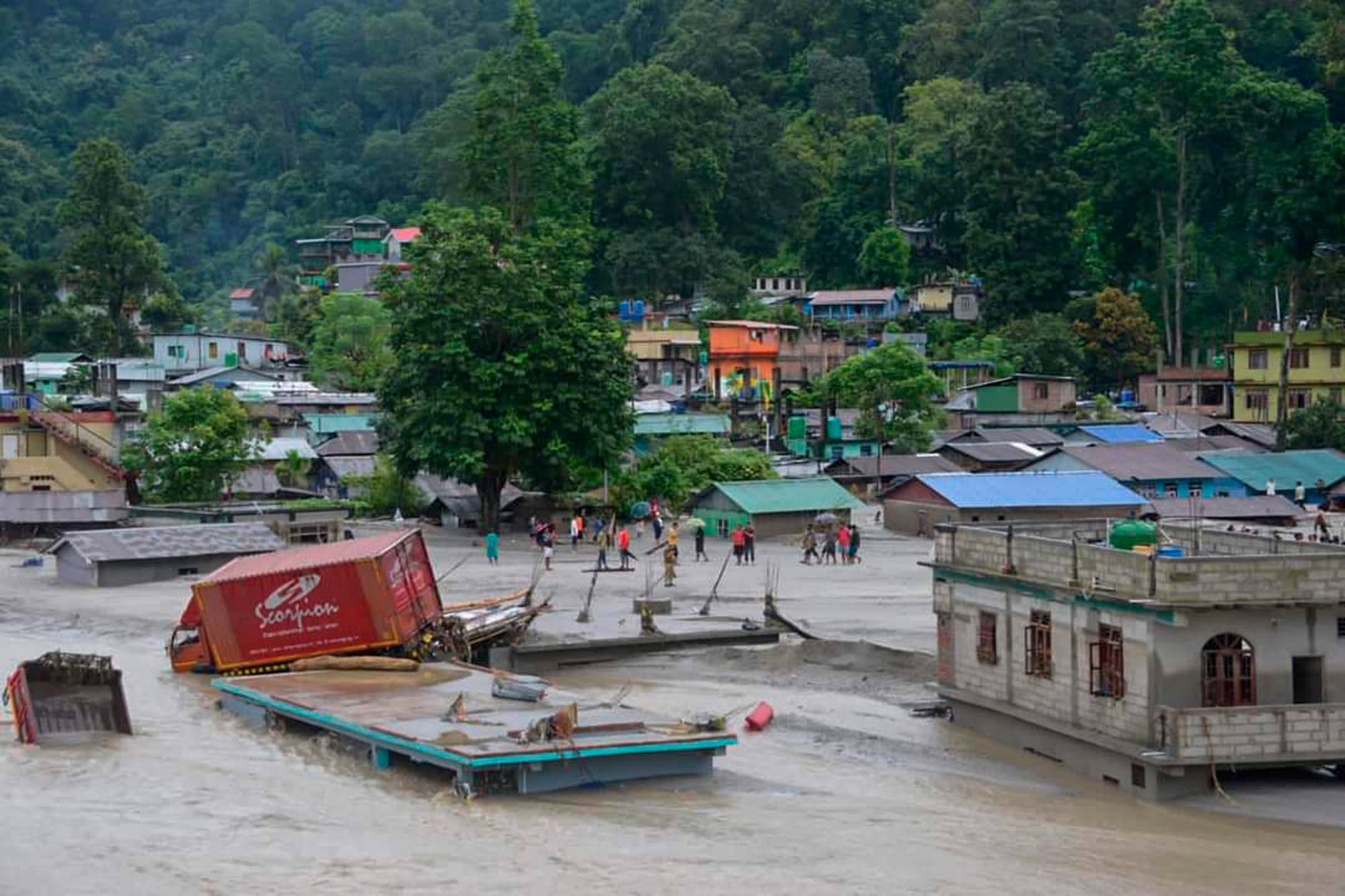<p>A vehicle that got washed away lies atop a submerged building after flash floods triggered by a sudden heavy rainfall swamped the Rangpo town in Sikkim, India, Thursday, 5 October 2023</p>