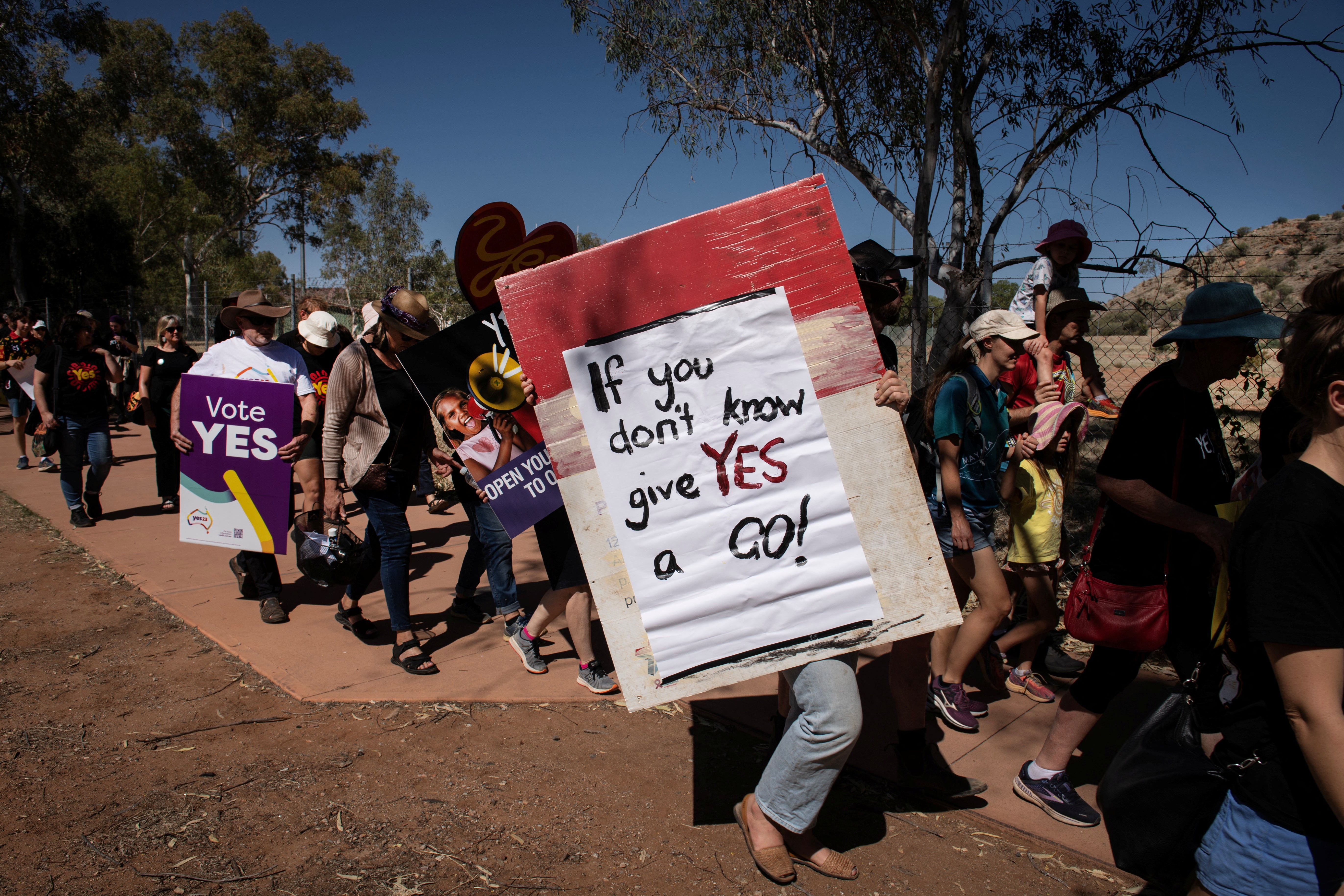 People rally during the Walk for Yes, hosted by the Yes23 campaign, at the Todd River in Alice Springs