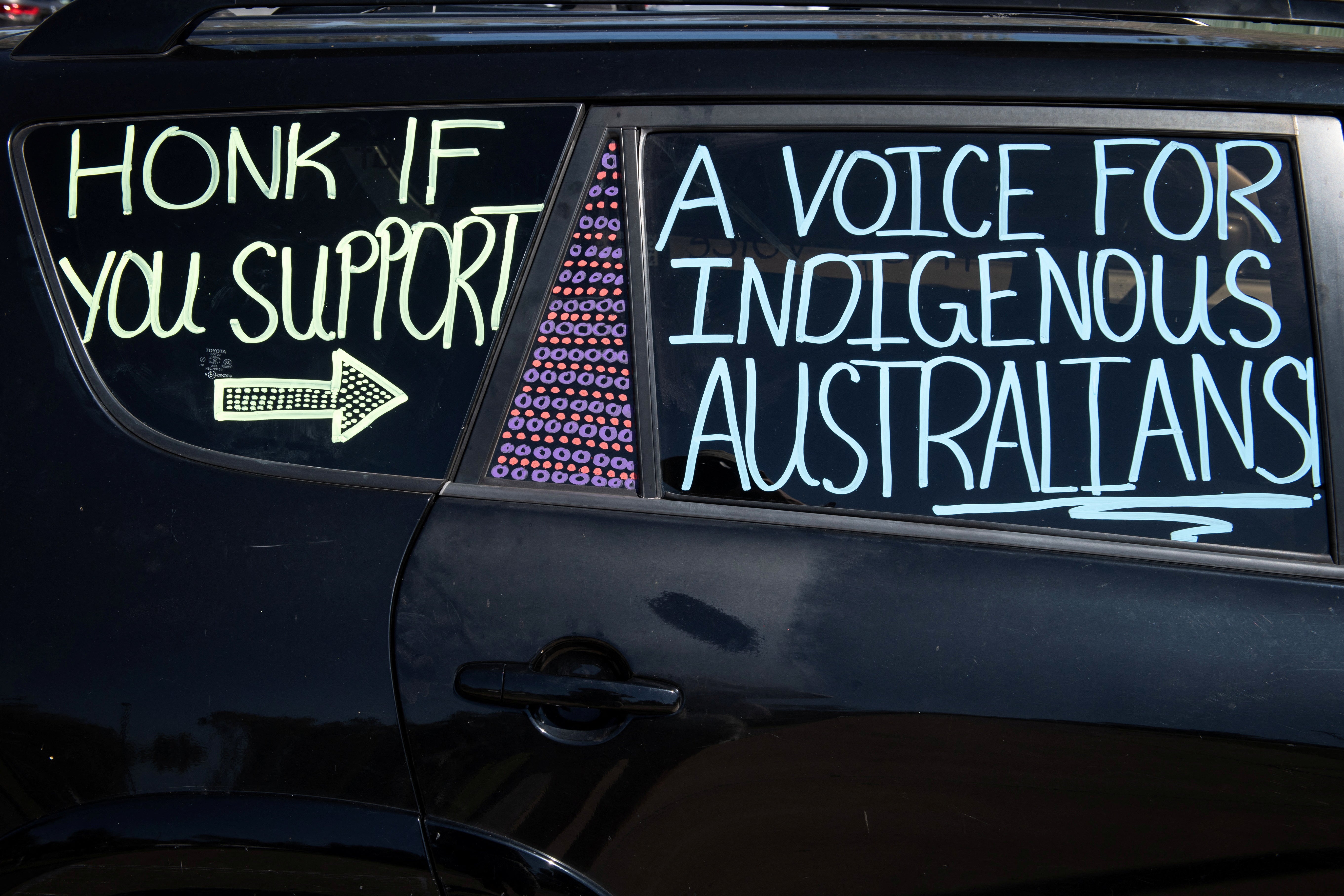 Writing on a car in Alice Springs shows support for the Voice