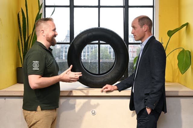 The Prince of Wales speaks to a staff member from ENSO (Kate Green/PA)