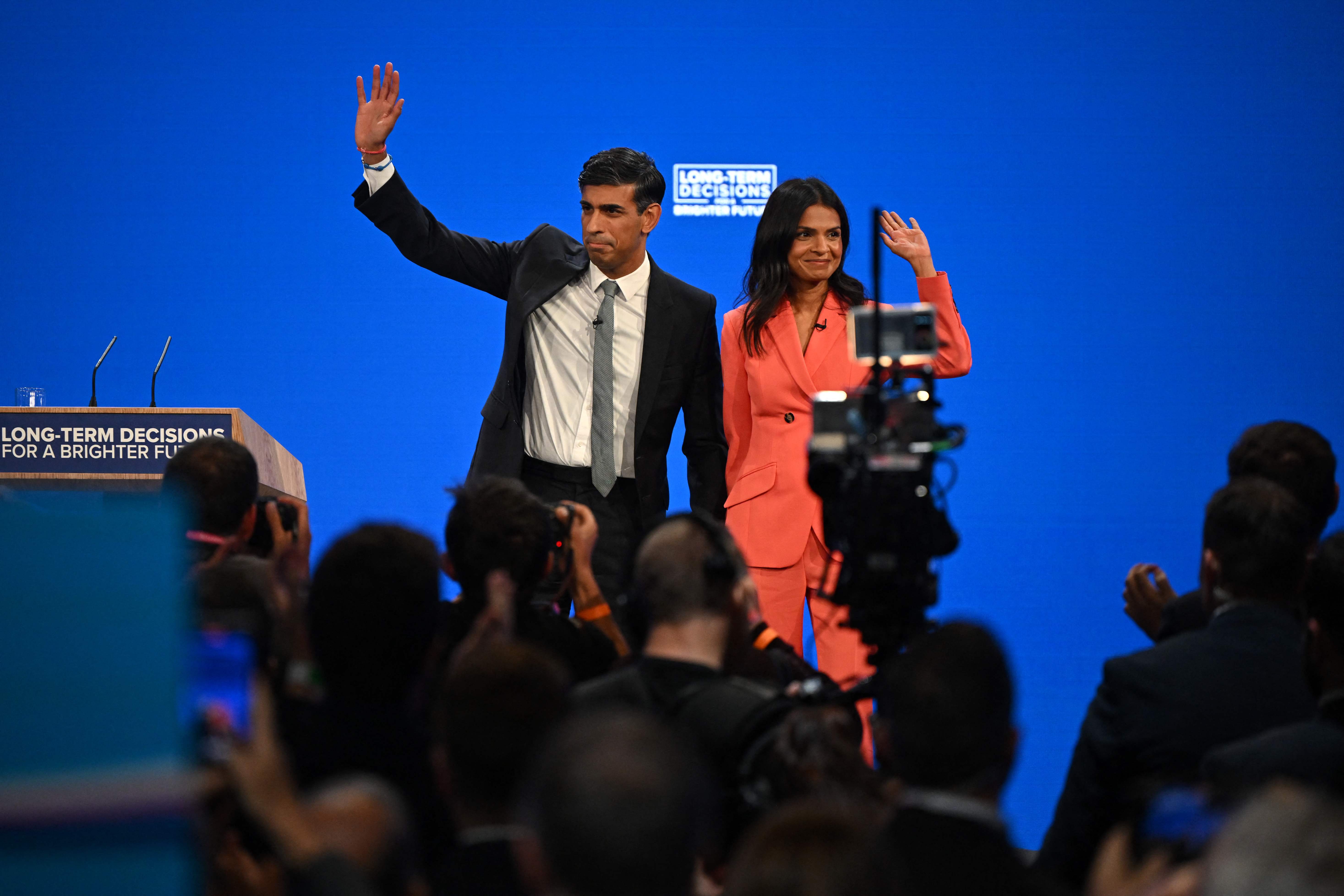 Britain’s Prime Minister Rishi Sunak and his wife Akshata Murty wave at the end of his speech
