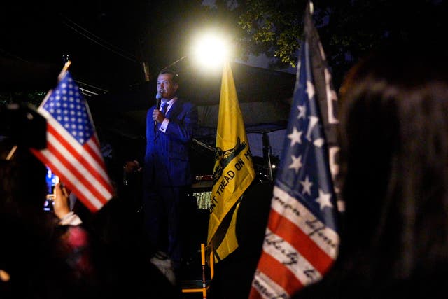 <p>Right-wing TV personality Johnny Tabacco speaks to a crowd of protesters outside of a migrant centre in Staten Island.  </p>