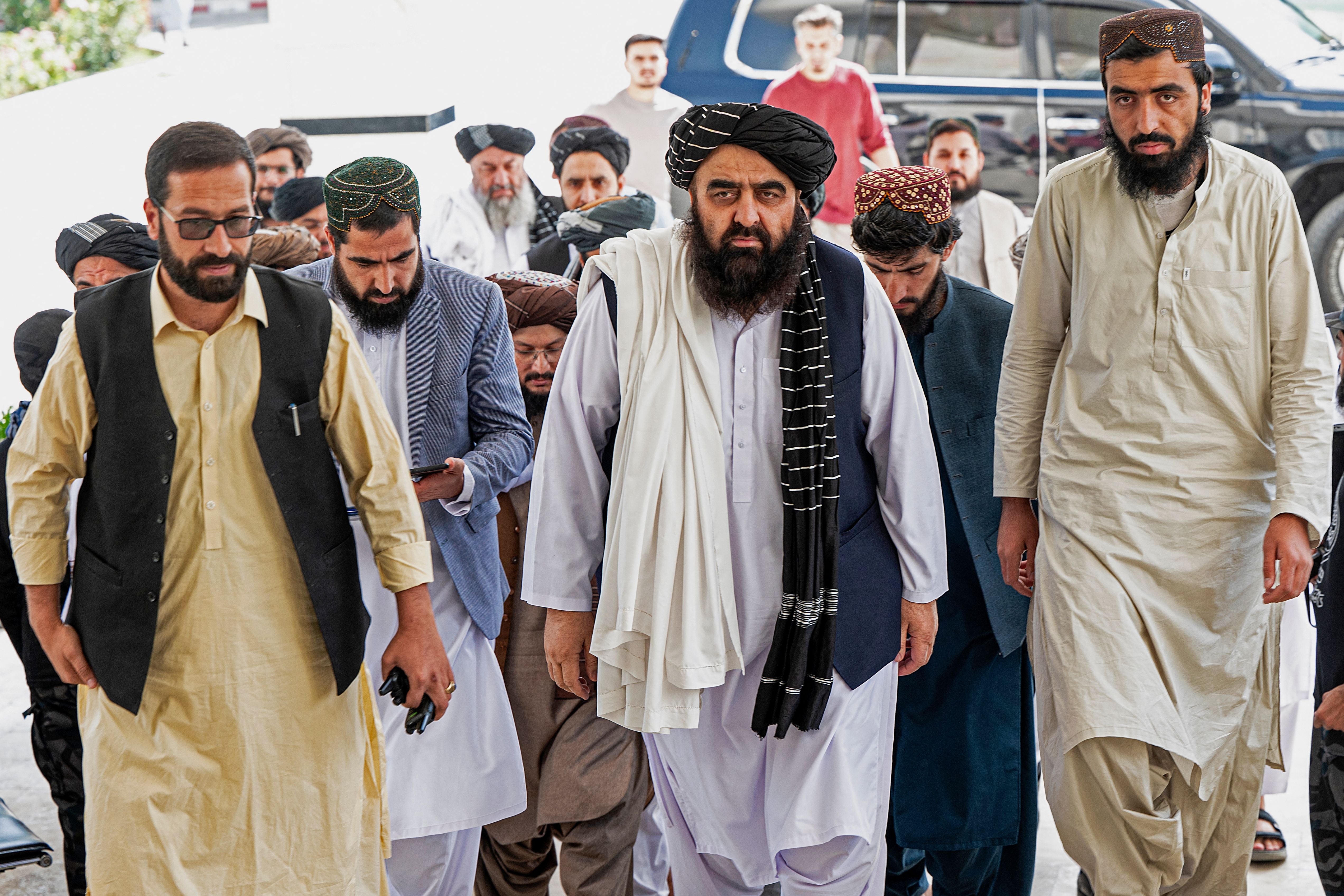Taliban’s minister of foreign affairs, Amir Khan Muttaqi (centre) arrives at a press conference in Kabul