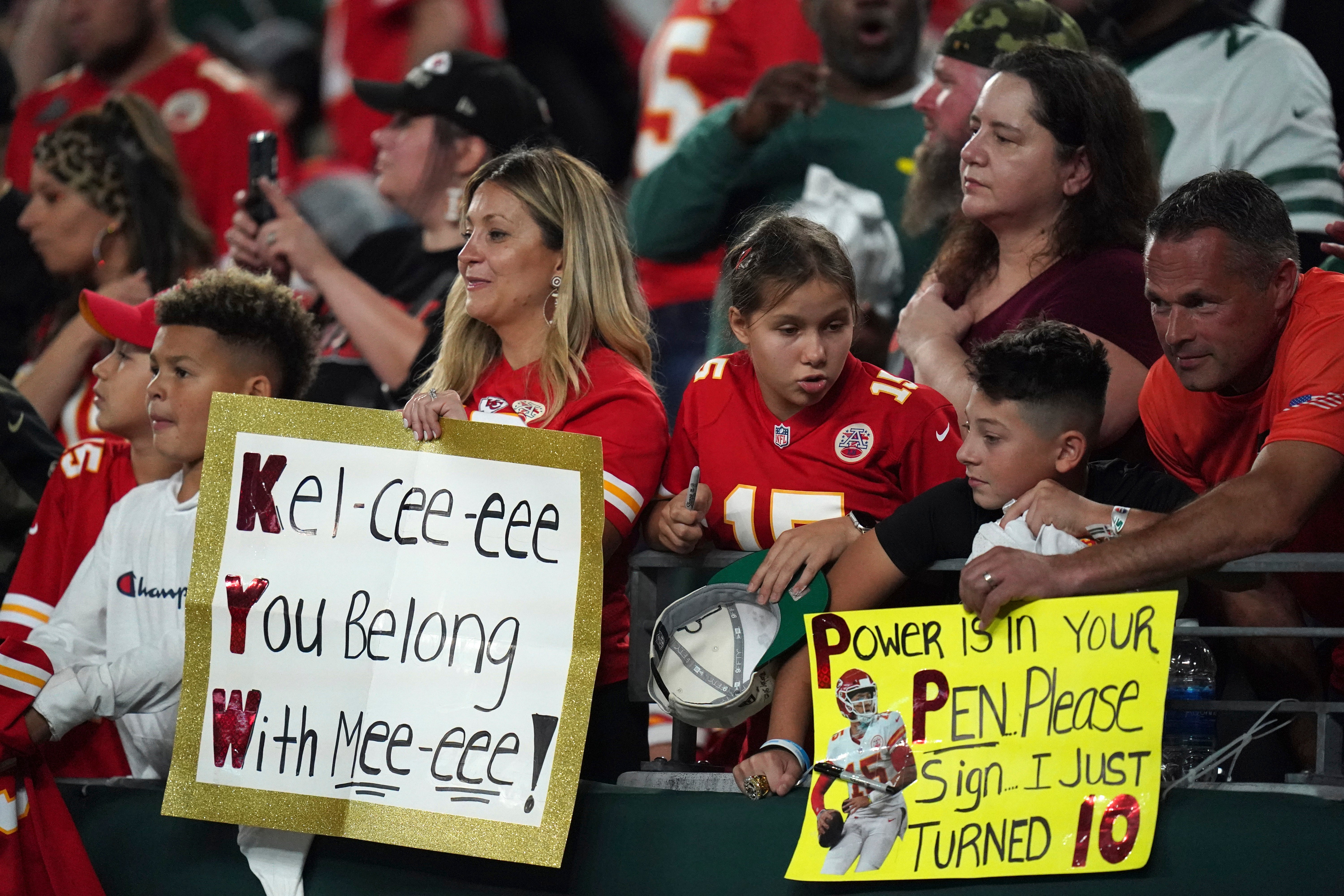 Fans hold signs during an NFL football game between the Kansas City Chiefs and the New York Jet