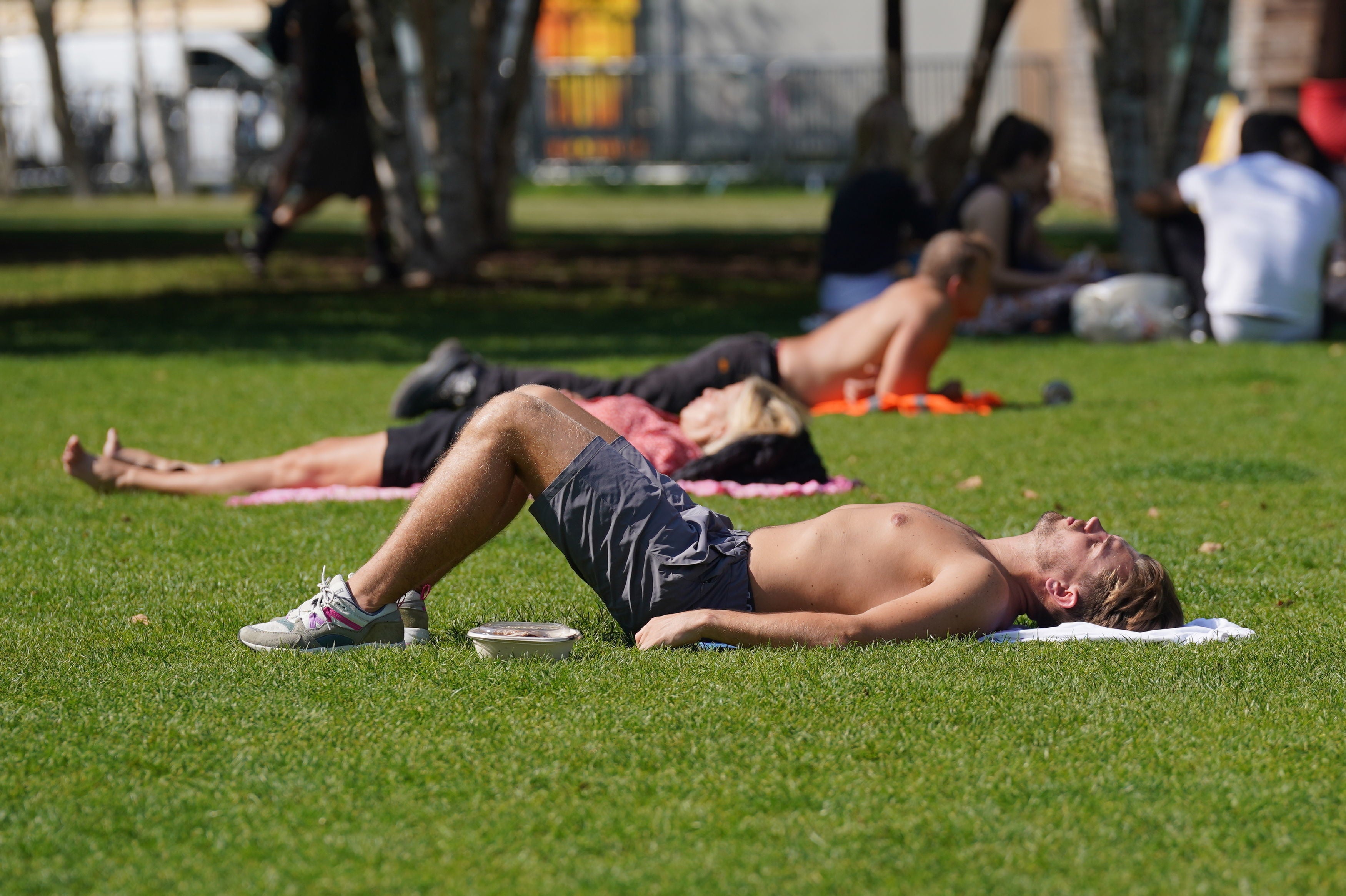 Sunbathers bask in Potters Field Park near London Bridge during the hottest September on record