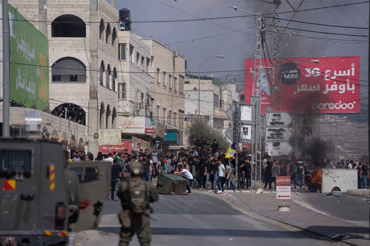 Palestinians march at youth's funeral procession after settler rampage in flashpoint West Bank town