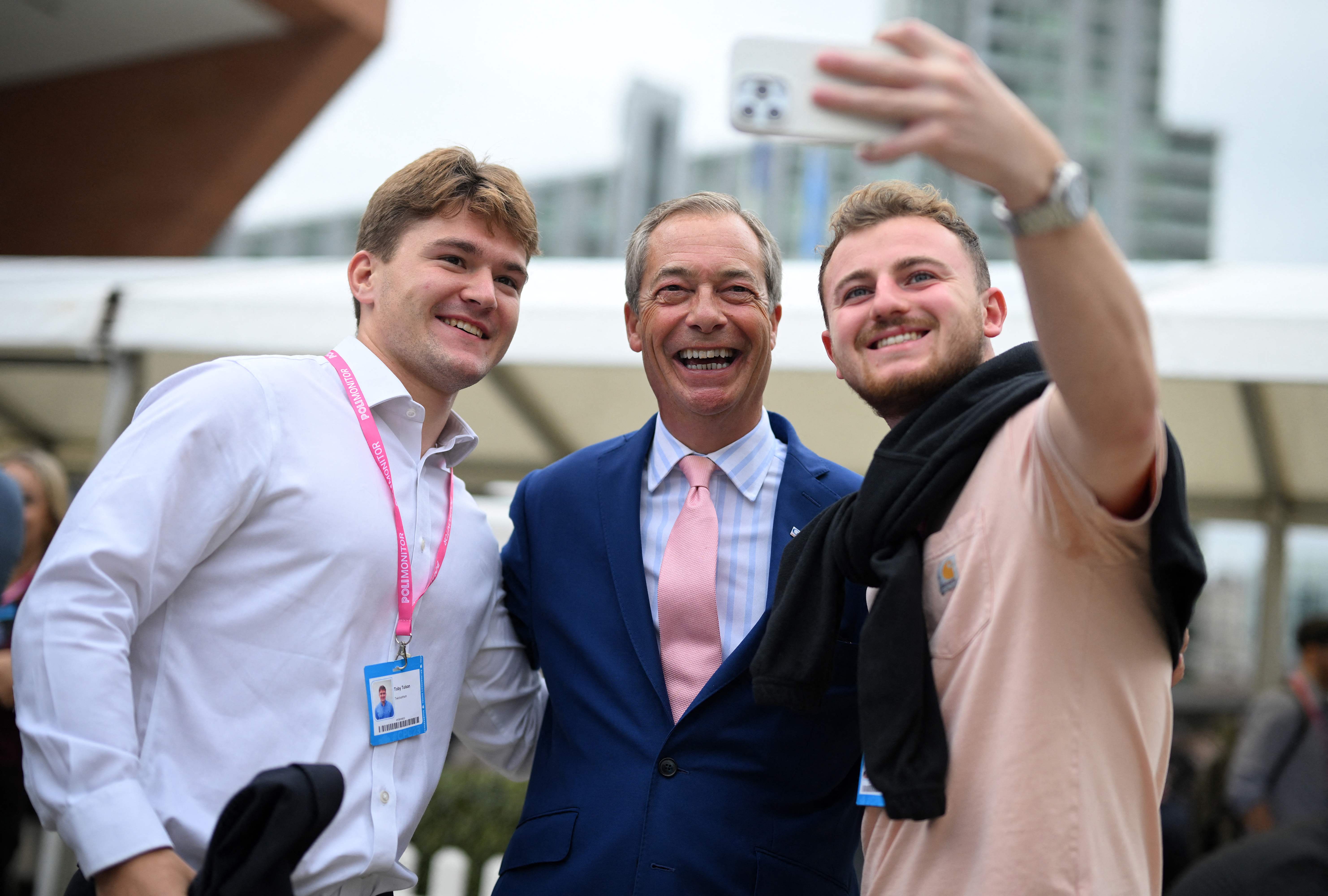 Delegates at the Tory conference pose with Nigel Farage in Manchester