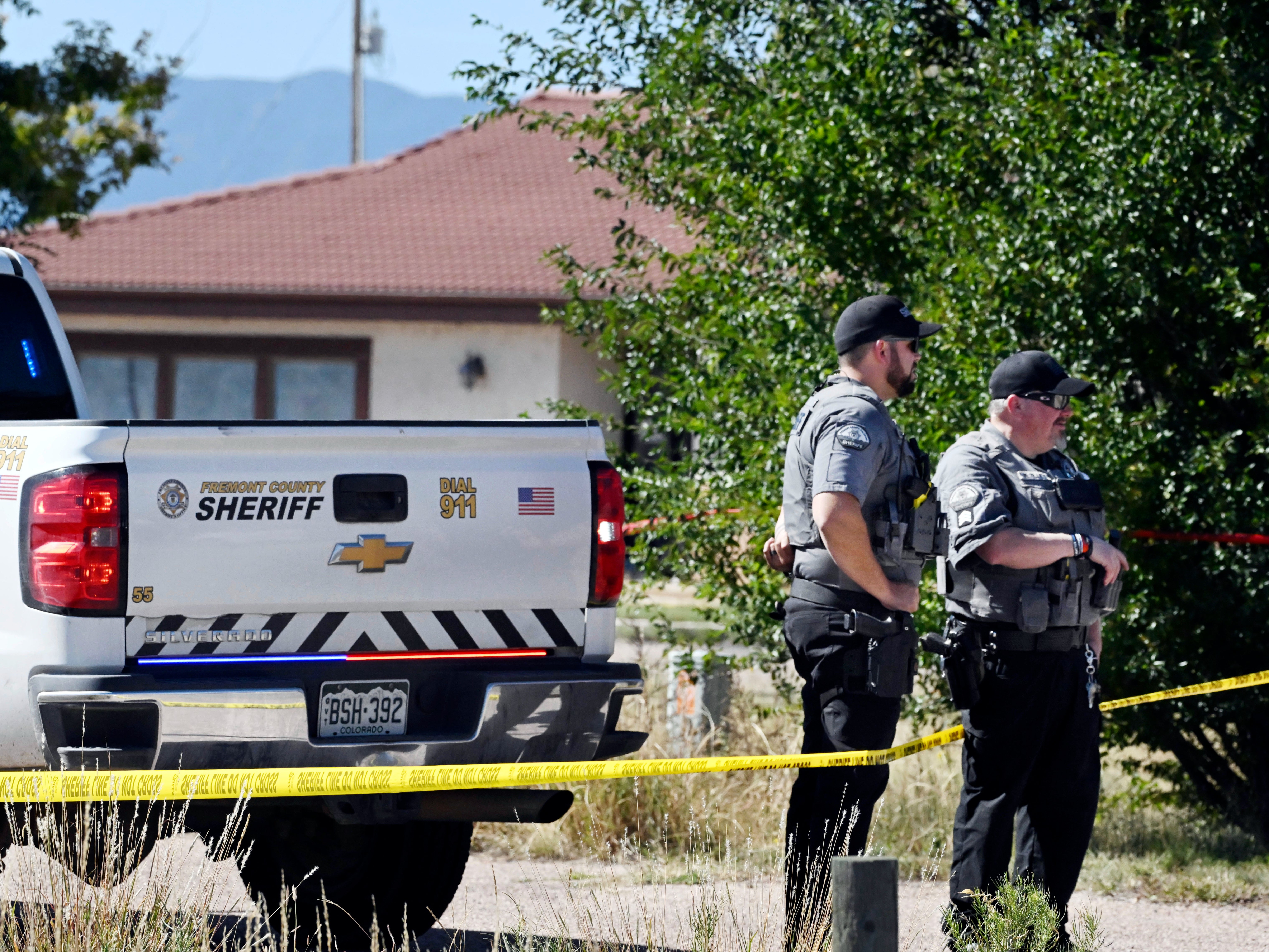 Fremont County deputies guard the road leading to the Return to Nature Funeral Home in Penrose, Colo. Thursday, Oct. 5, 2023