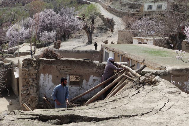 <p>Residents remove debris from the rooftop of damaged a house at Sooch village in Jurm district of Badakhshan Province </p>
