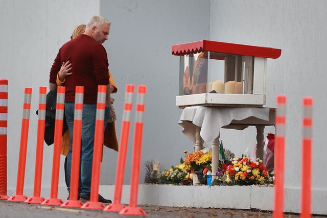 Donna and Hugh Harper, the parents of 14-year-old Leona Harper who died in the explosion, lay a wreath at a commemoration and remembrance service in Creeslough, Co Donegal on the first anniversary of the explosion at a service station which killed 10 people. Picture date: Saturday October 7, 2023.