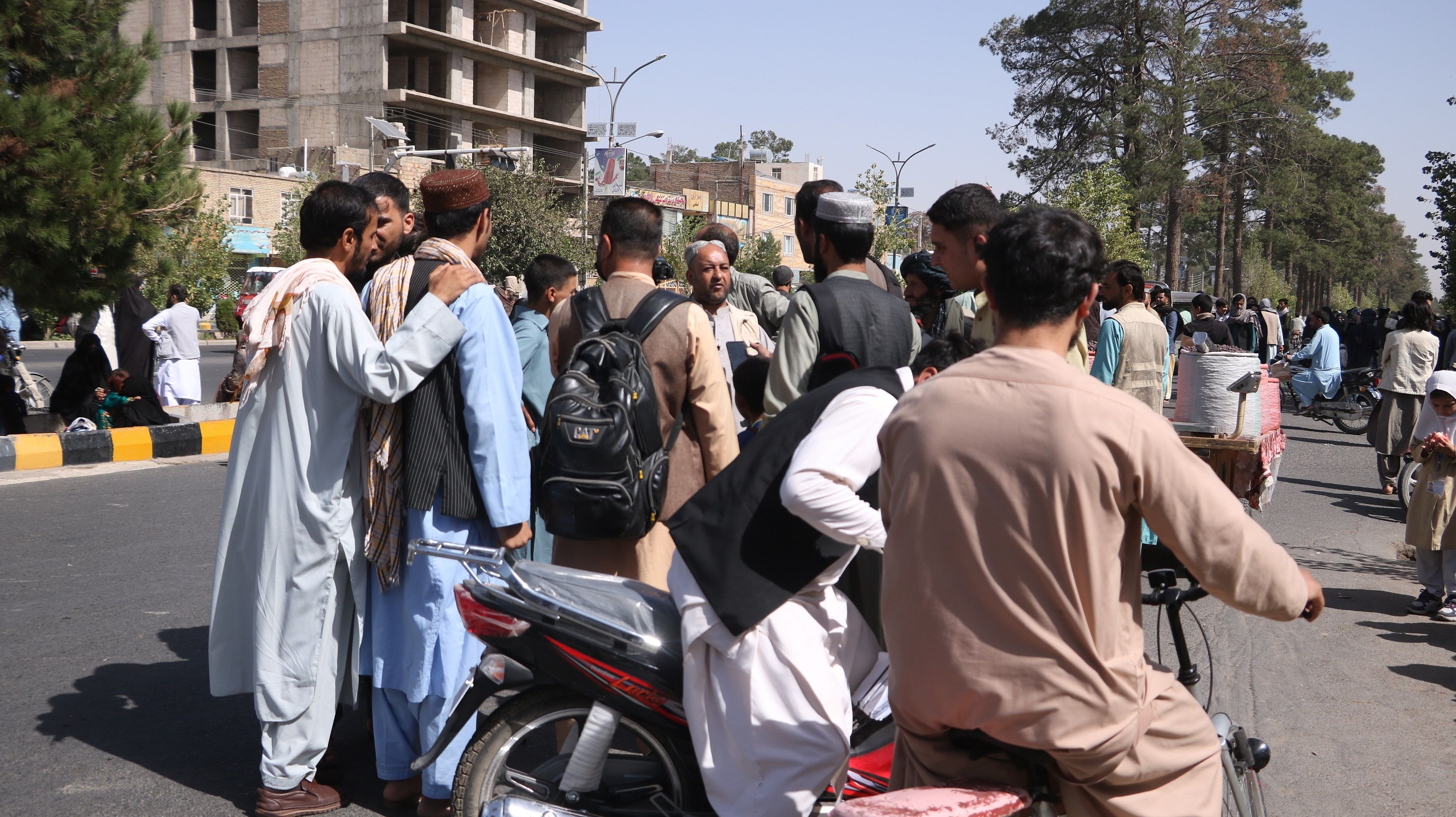 Residents come out onto a street after an earthquake rocked the city of Herat