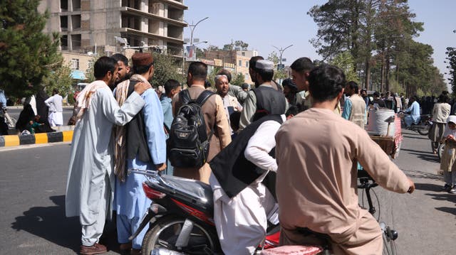 <p>Residents come out onto a street after an earthquake rocked the city of Herat</p>