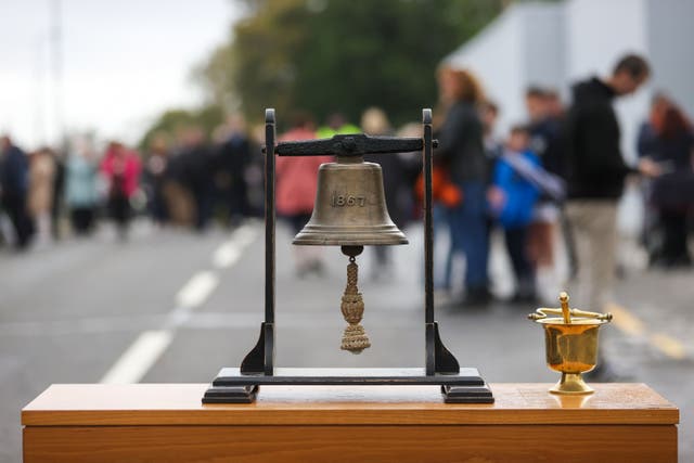 A bell was rung ten times as the ten names were read out of those who died (Liam McBurney/PA)