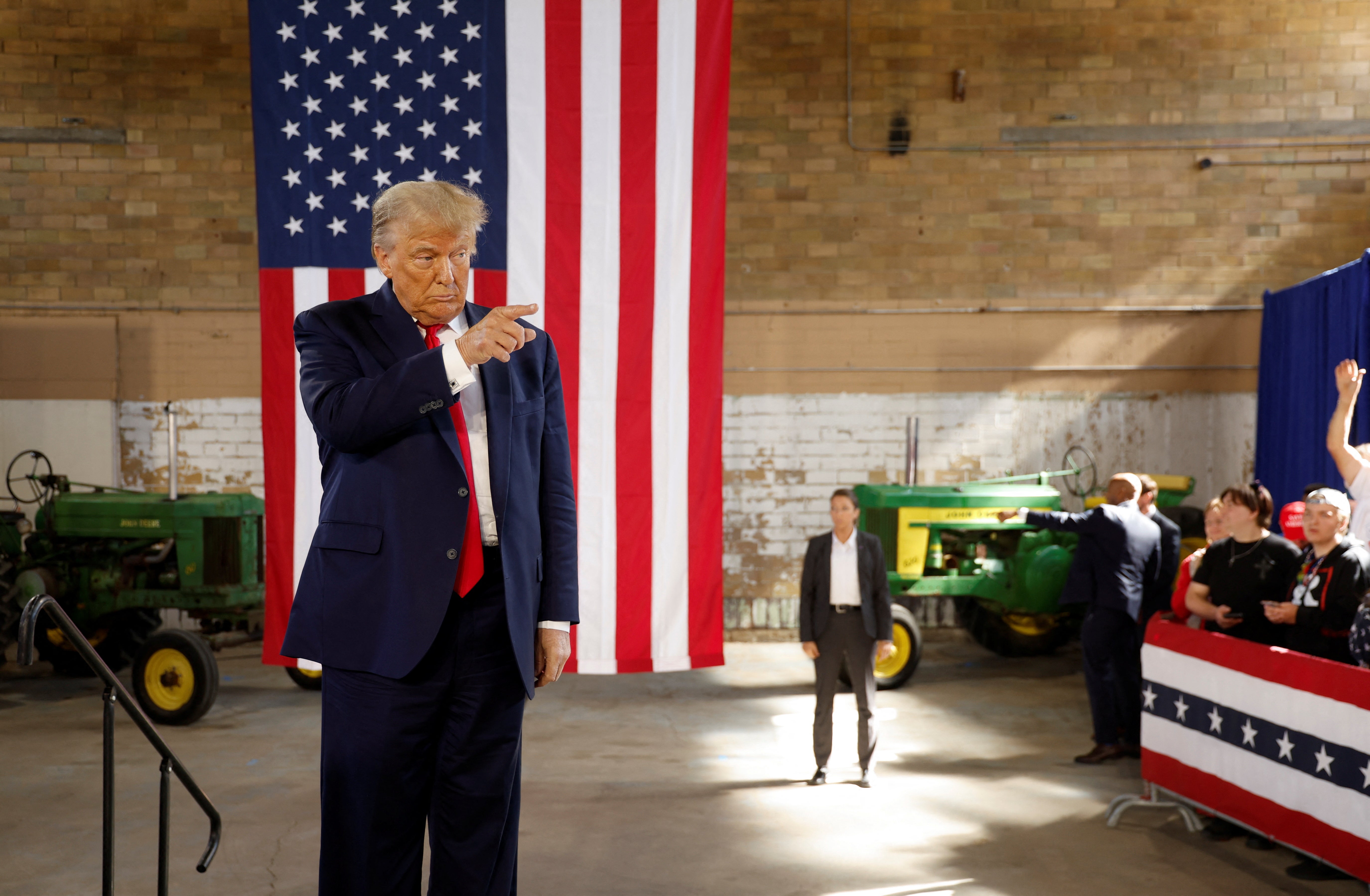 Former U.S. President and Republican presidential candidate Donald Trump gestures as he rallies with supporters at a "commit to caucus" event at the National Cattle Congress event space in Waterloo, Iowa, U.S. October 7, 2023