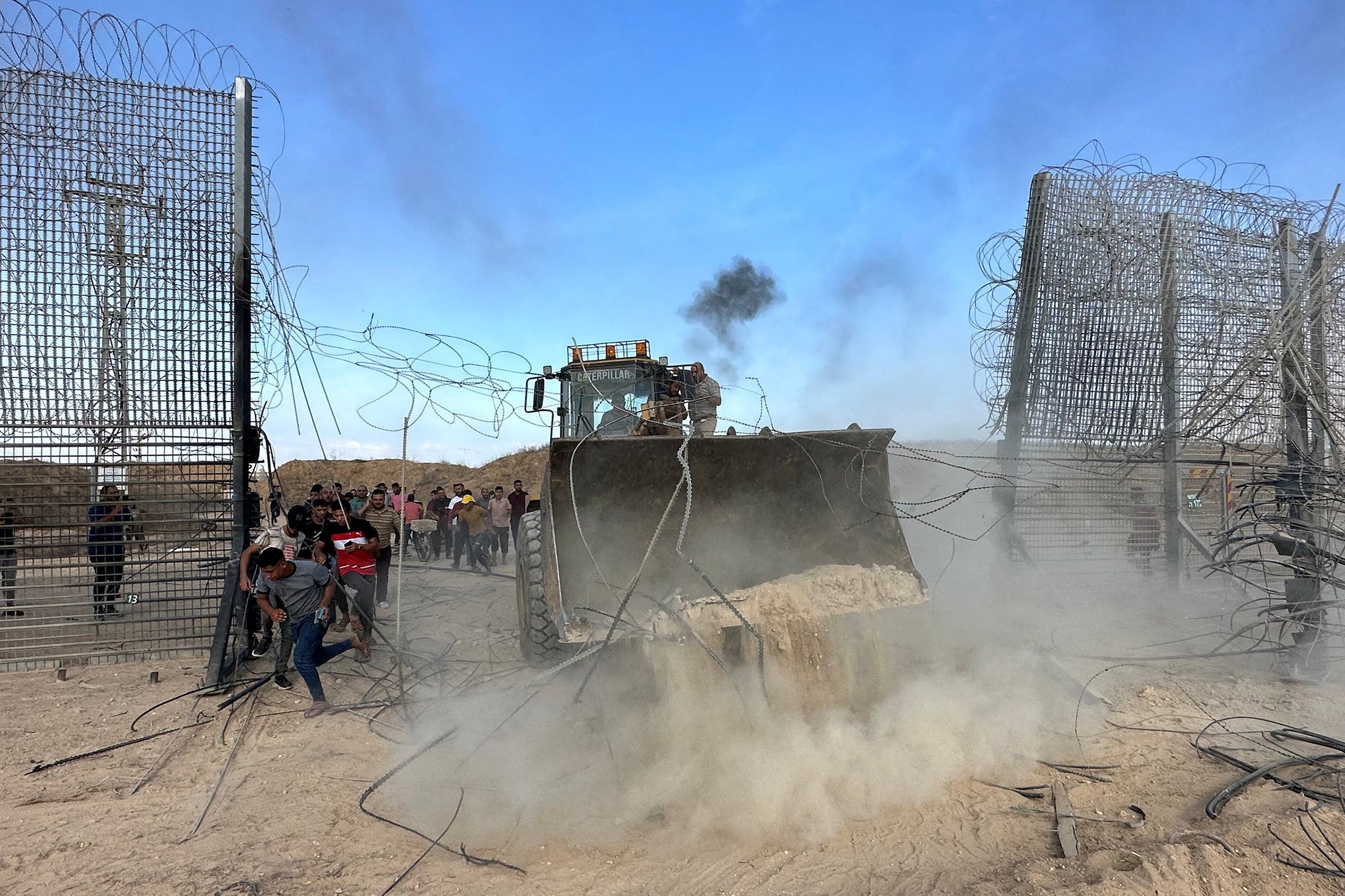 Palestinians break into the Israeli side of Israel-Gaza border fence after gunmen infiltrated areas of southern Israel