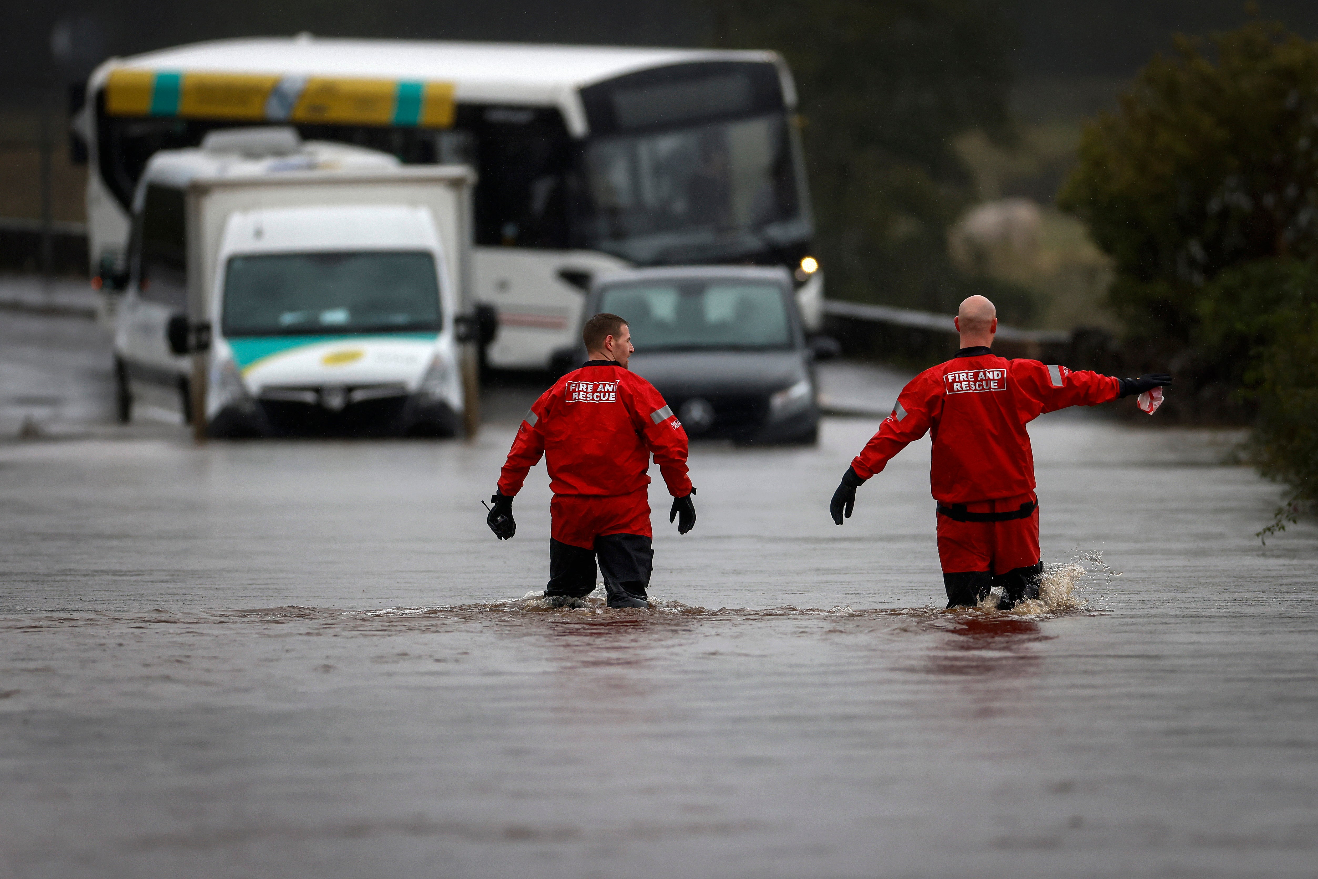Members of the public struggle with flooding in Drymen, Scotland, after amber weather warnings were issued across much of the country.