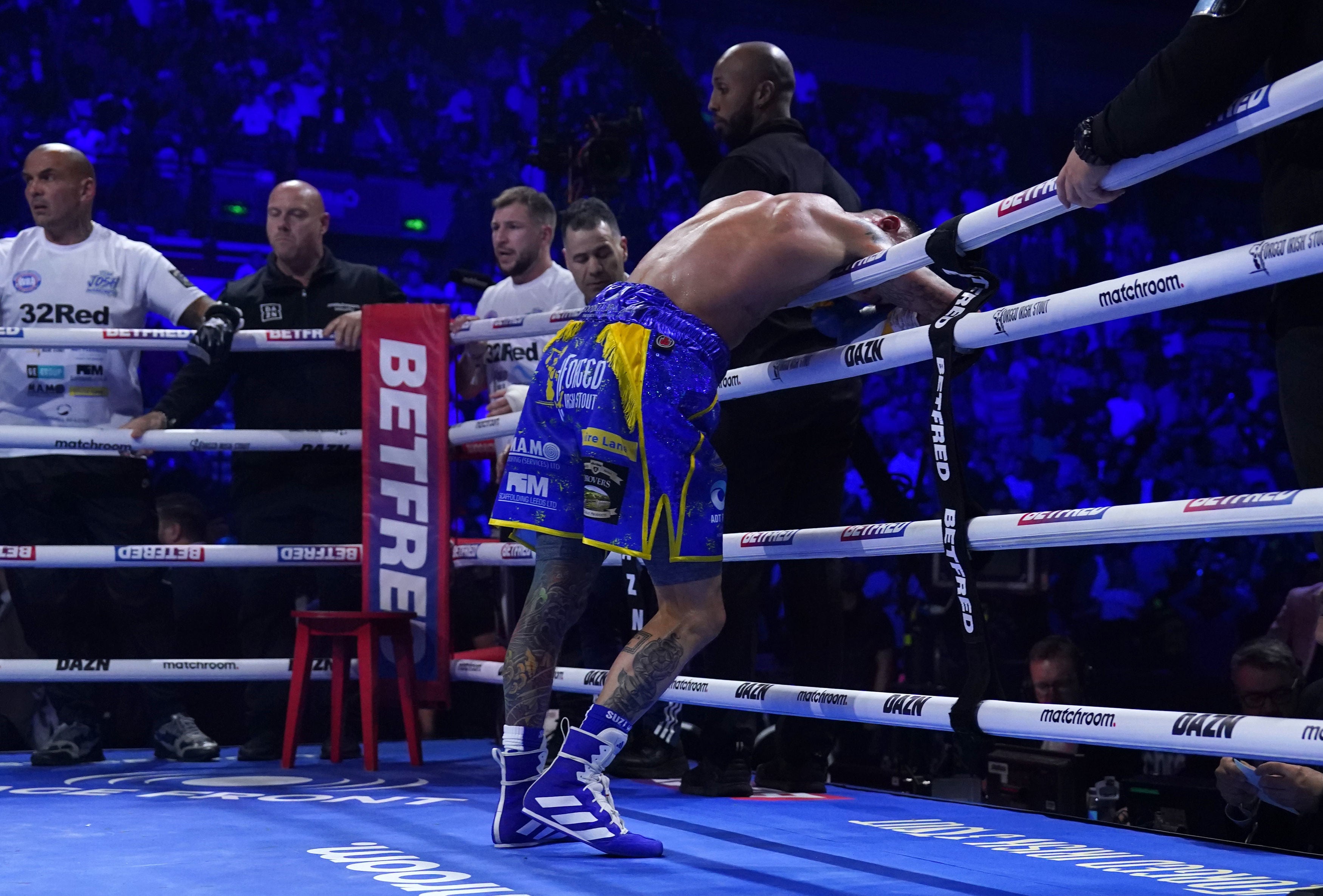 Josh Warrington reacts after being stopped by Leigh Wood against the run of the action