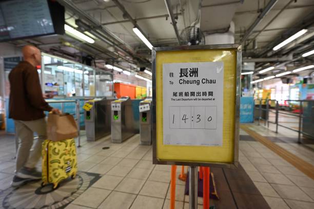 A sign shows the time of the last ferry to the outlying island of Cheung Chau as Hong Kong hoisted typhoon signal no 8 around noon on 8 October 2023