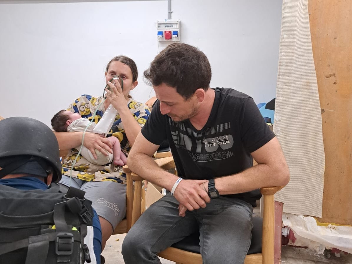 Aimee Labban, her husband Uriel, and newborn Kai, receive treatment after being rescued by the IDF.