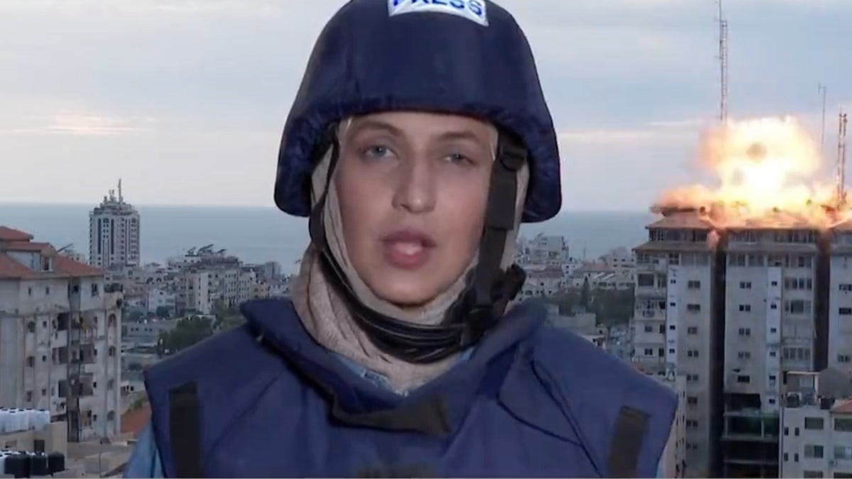 Reporter runs for cover as Gaza tower block hit by airstrike on live TV