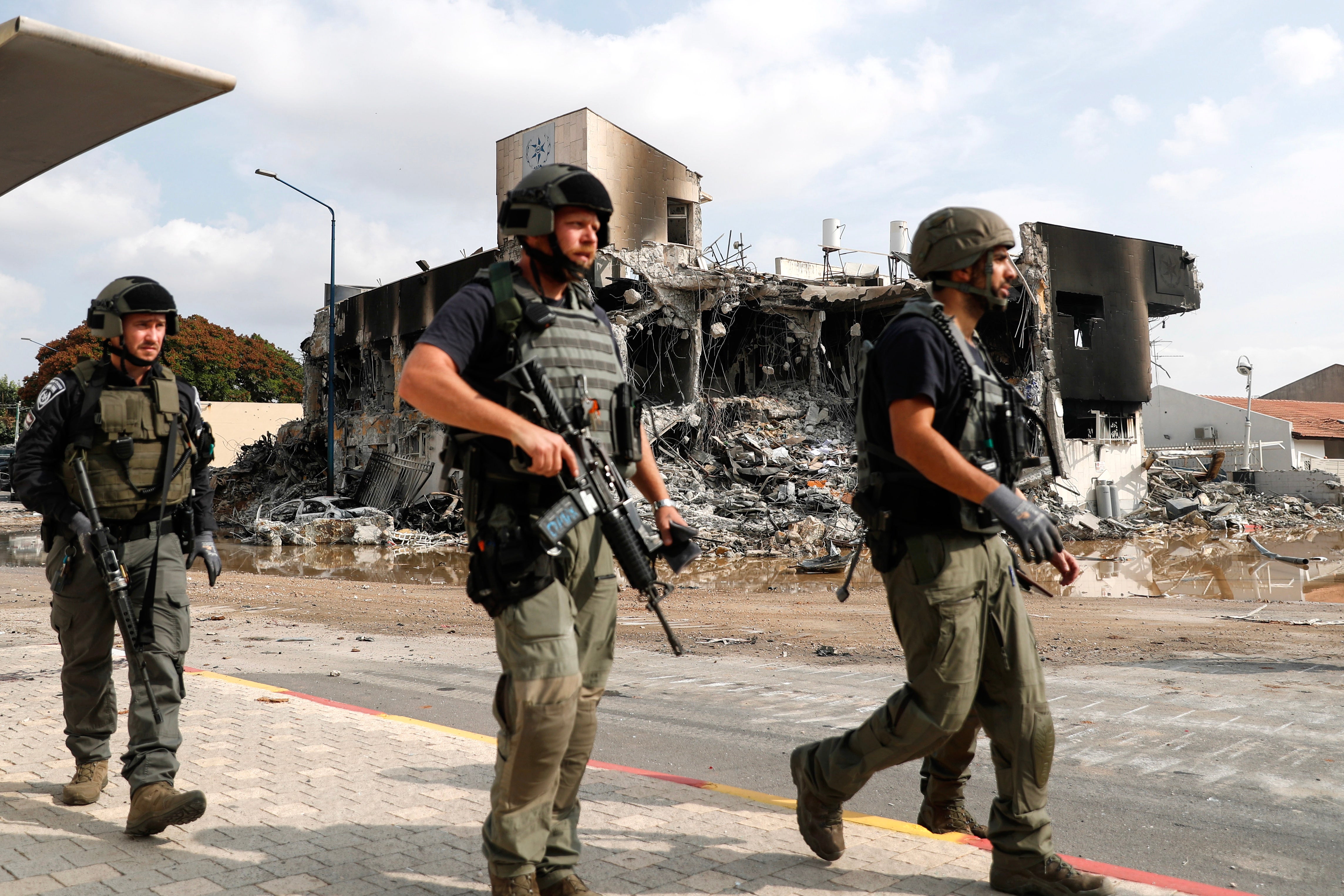 Israeli security forces patrol outside the destroyed police station that was controlled by Hamas militants in the southern city of Sderot, close to the Gaza border, on Sunday