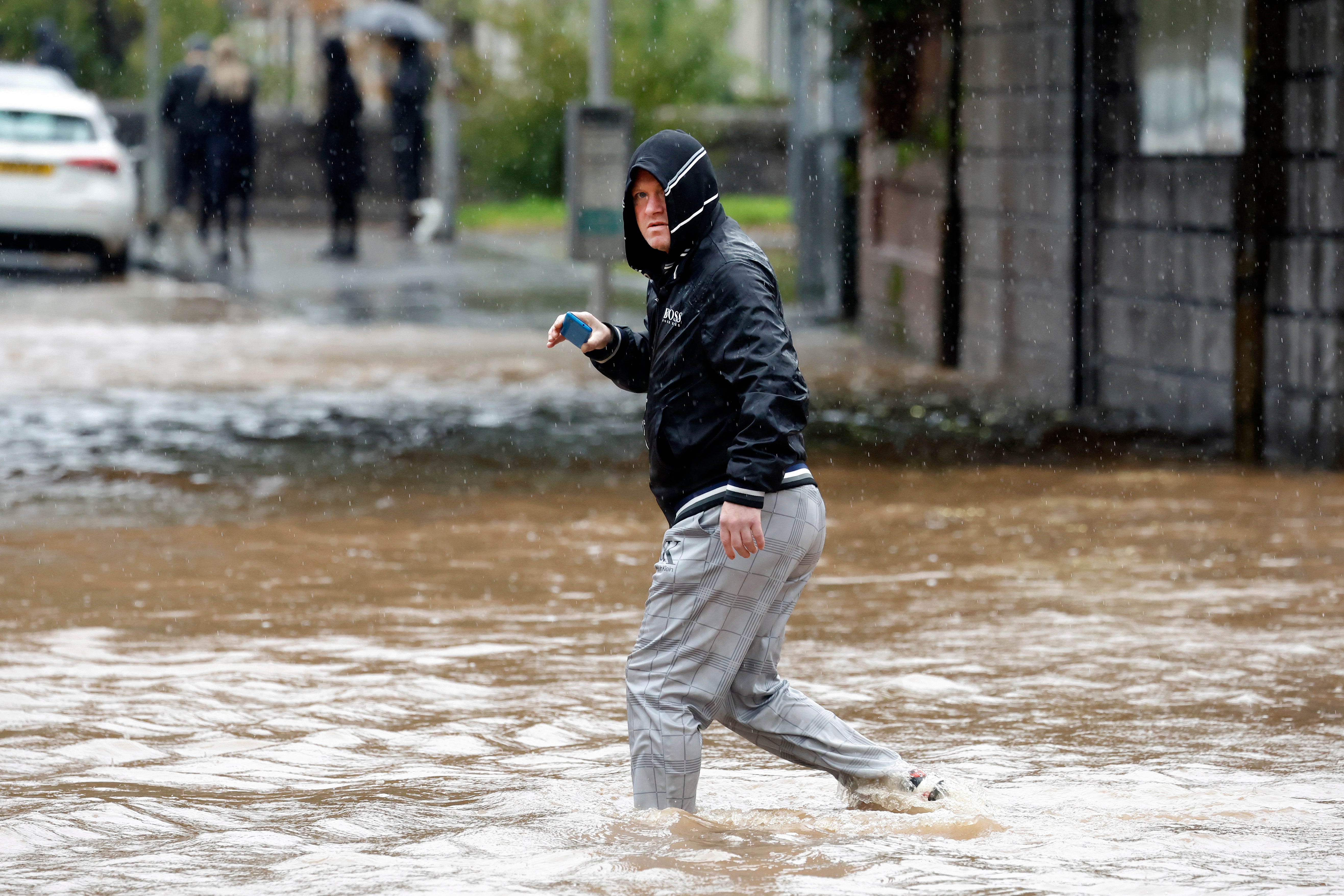 Members of the public struggle with flooding as torrential rain continues