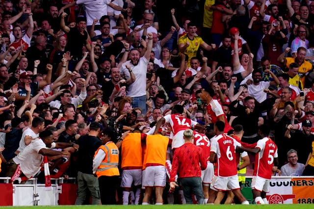 Arsenal players celebrate with the fans after Gabriel Martinelli’s winner (John Walton/PA)