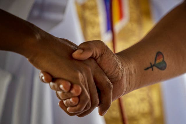 <p>A Filipino same-sex couple hold hands as they tie the knot in a mass wedding ceremony on June 25, 2023 in Quezon city, Metro Manila, Philippines</p>