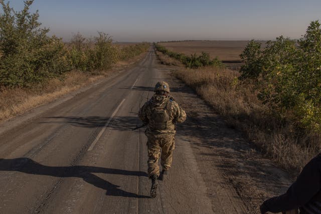 <p>A Ukrainian soldier of the 65th Mechanized Brigade walks on a road near the frontline village of Robotyne, in the Zaporizhzhia region</p>
