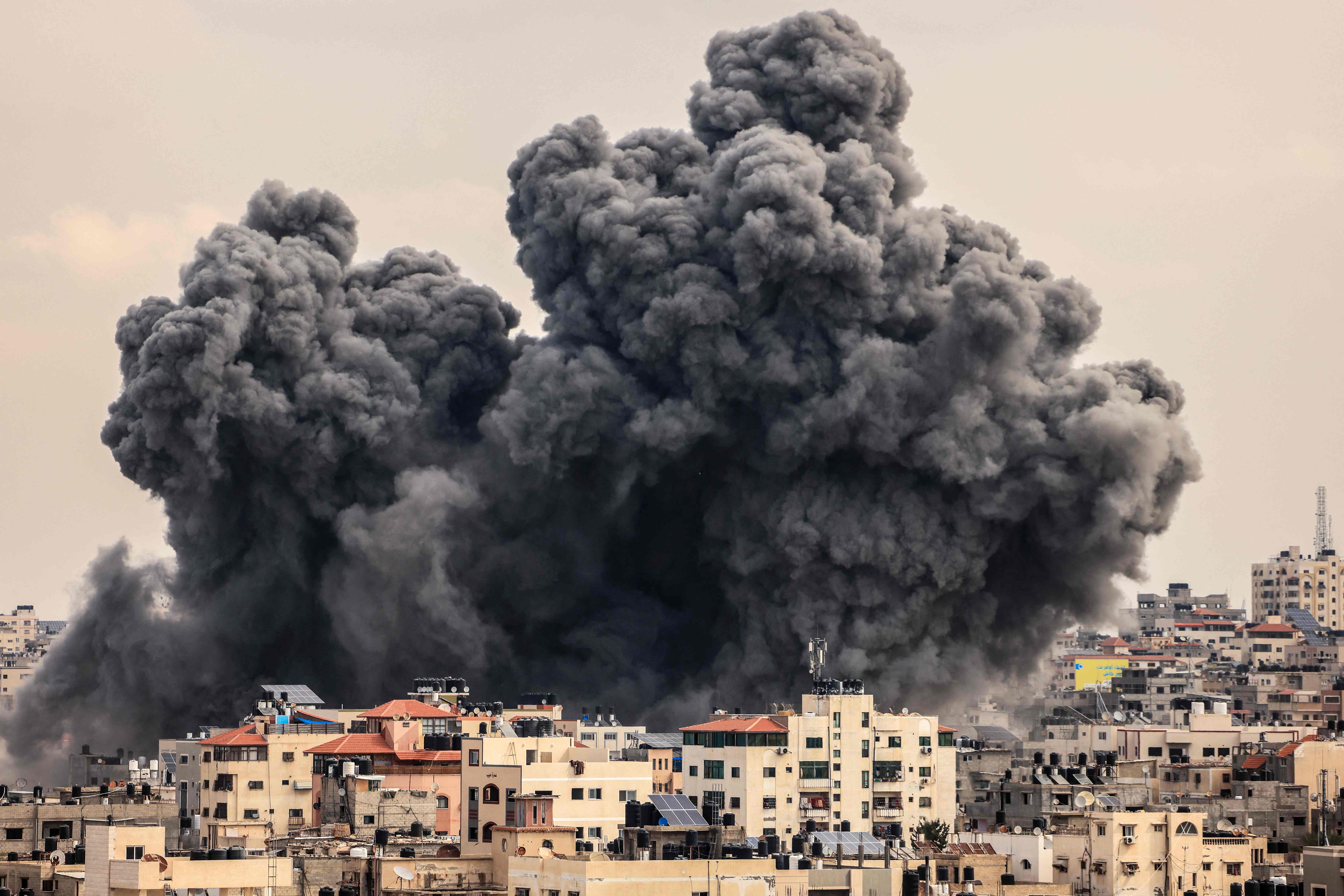 A plume of smoke rises in the sky of Gaza City during an Israeli airstrike on the third day since Hamas launched its attack on Israel