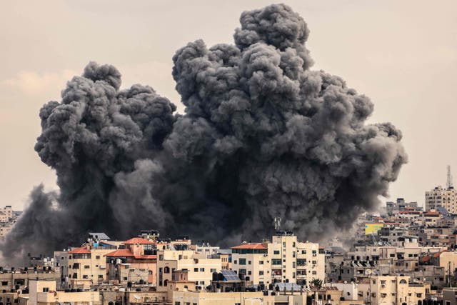 <p>A plume of smoke rises following an Israeli airstrike on Gaza City</p>