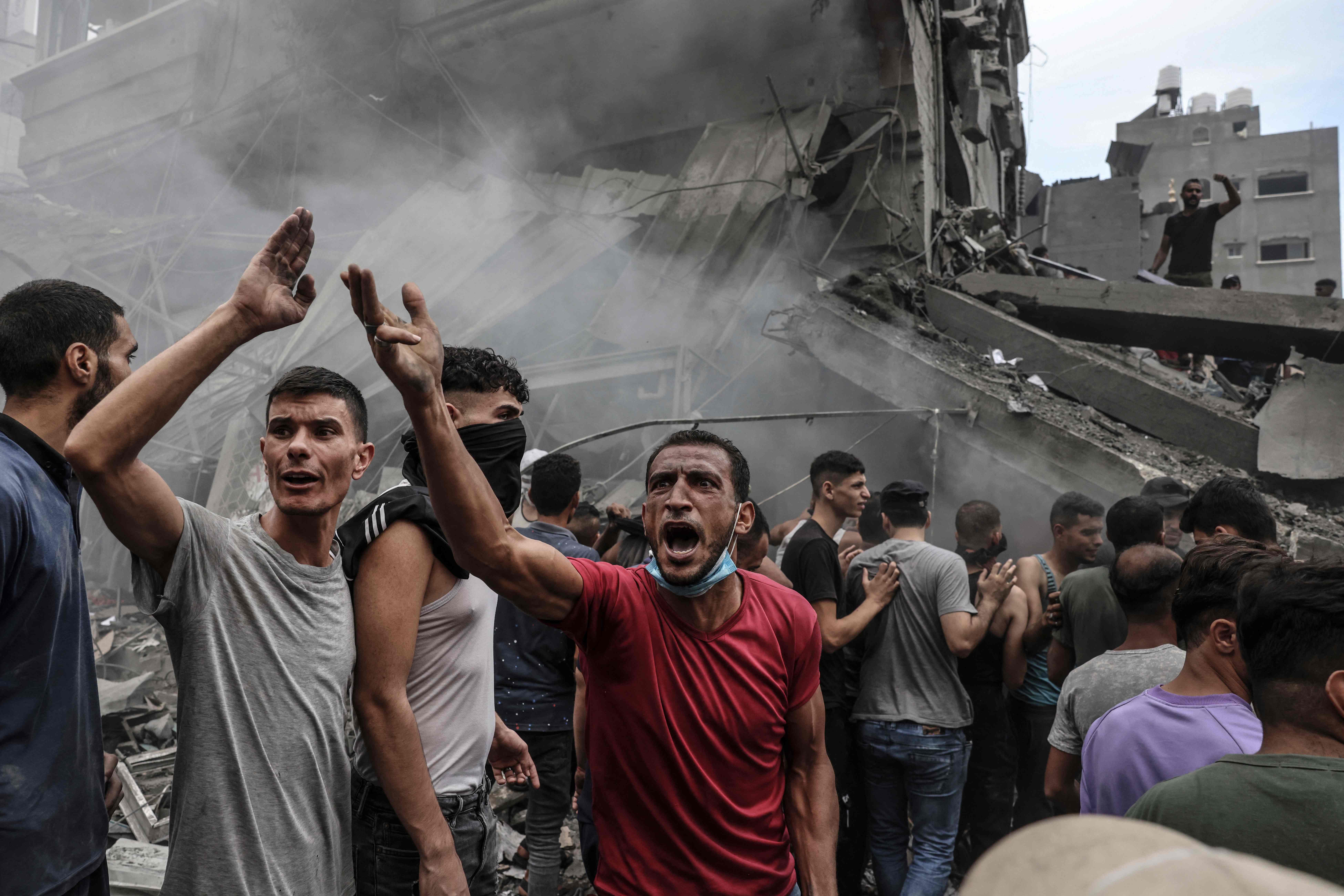 Palestinians search for survivors after an Israeli airstrike on buildings in the refugee camp of Jabalia in the Gaza Strip