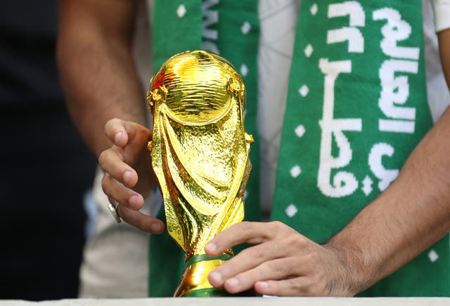 <p>A Saudi Arabia fan with a replica World Cup Trophy during the Fifa World Cup Qatar 2022</p>