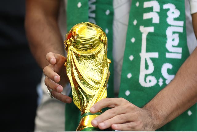 <p>A Saudi Arabia fan with a replica World Cup Trophy during the Fifa World Cup Qatar 2022</p>