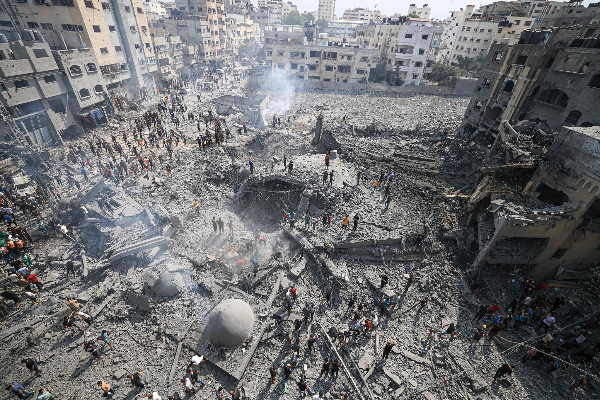 Palestinians seen inspecting the damage at the Al-Sousi mosque