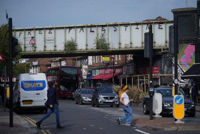 <p>Pro Palestinian graffiti was sprayed on a railway bridge in Golders Green, north London, an area with a prominent Jewish population (Yui Mok/PA)</p>