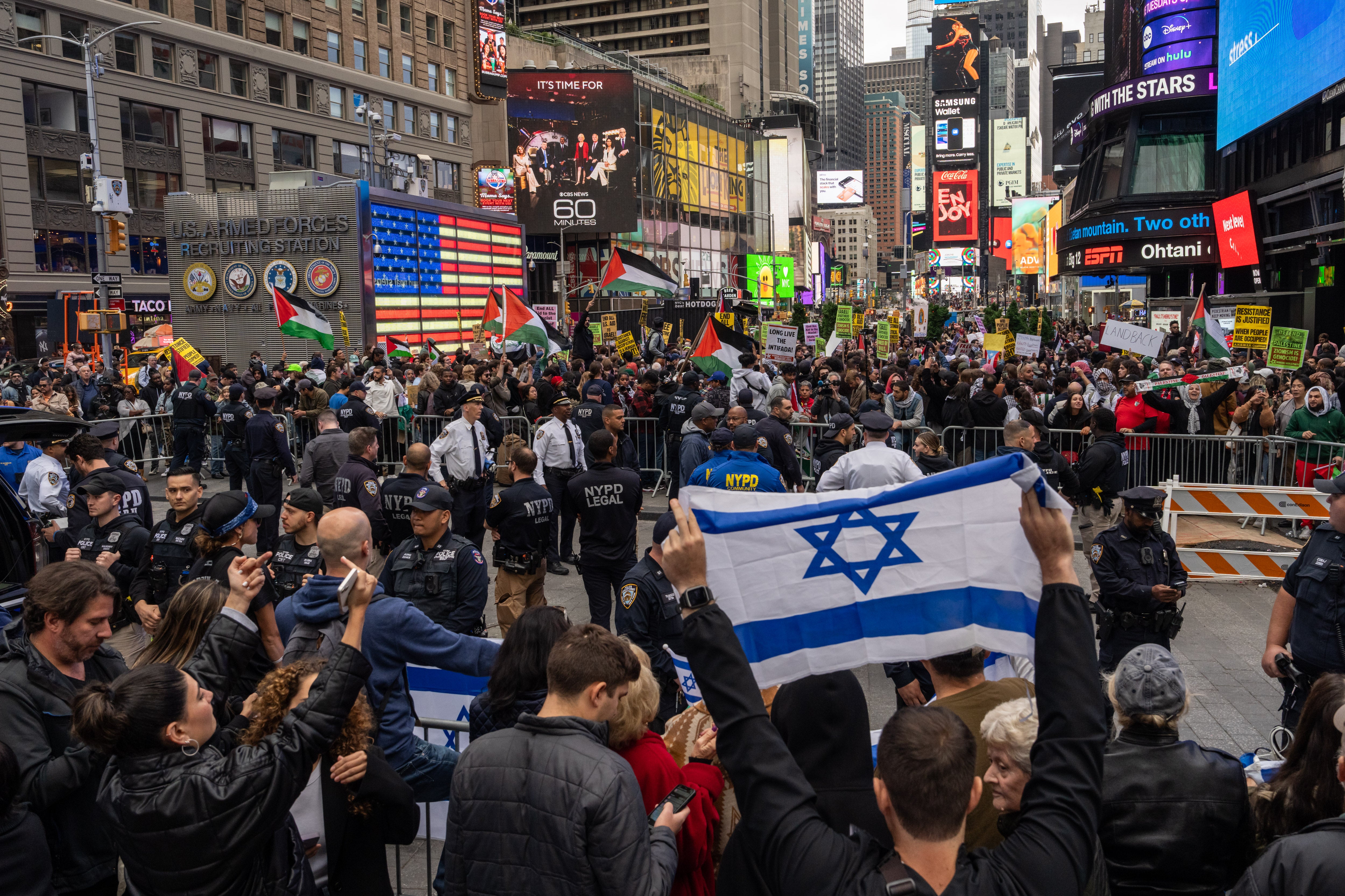 Demonstrators in support of the Palestinian people face pro-Israel counter-protesters in Times Square