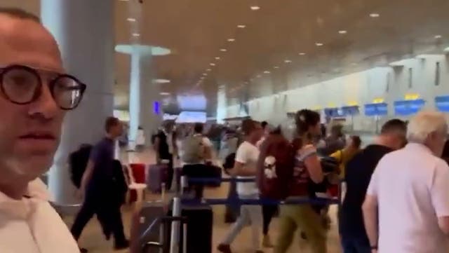 <p>Desperate travellers ditch luggage and race to board planes out of Israel as rockets fired nearby.</p>