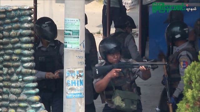 <p>File: A policeman aims his gun as security forces stage a crackdown on demonstrations in Kachin state</p>