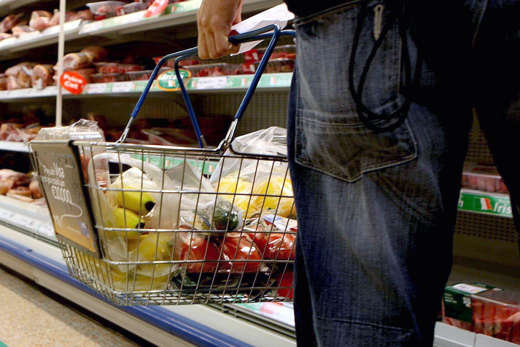 Undated file photo of a person holding a shopping basket in a supermarket.