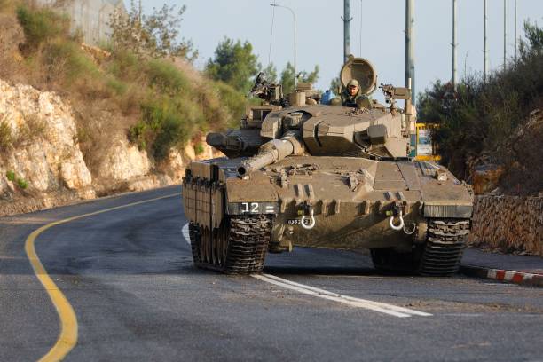 An Israeli army Merkava tank blocks one of the entrances to the northern Israeli kibbutz of Misgav Am near the border with Lebanon on 10 October 2023
