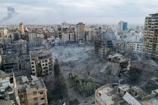 <p>This aerial photo show heavily damaged buildings following Israeli airstrikes in Gaza City on 10 October 2023</p>